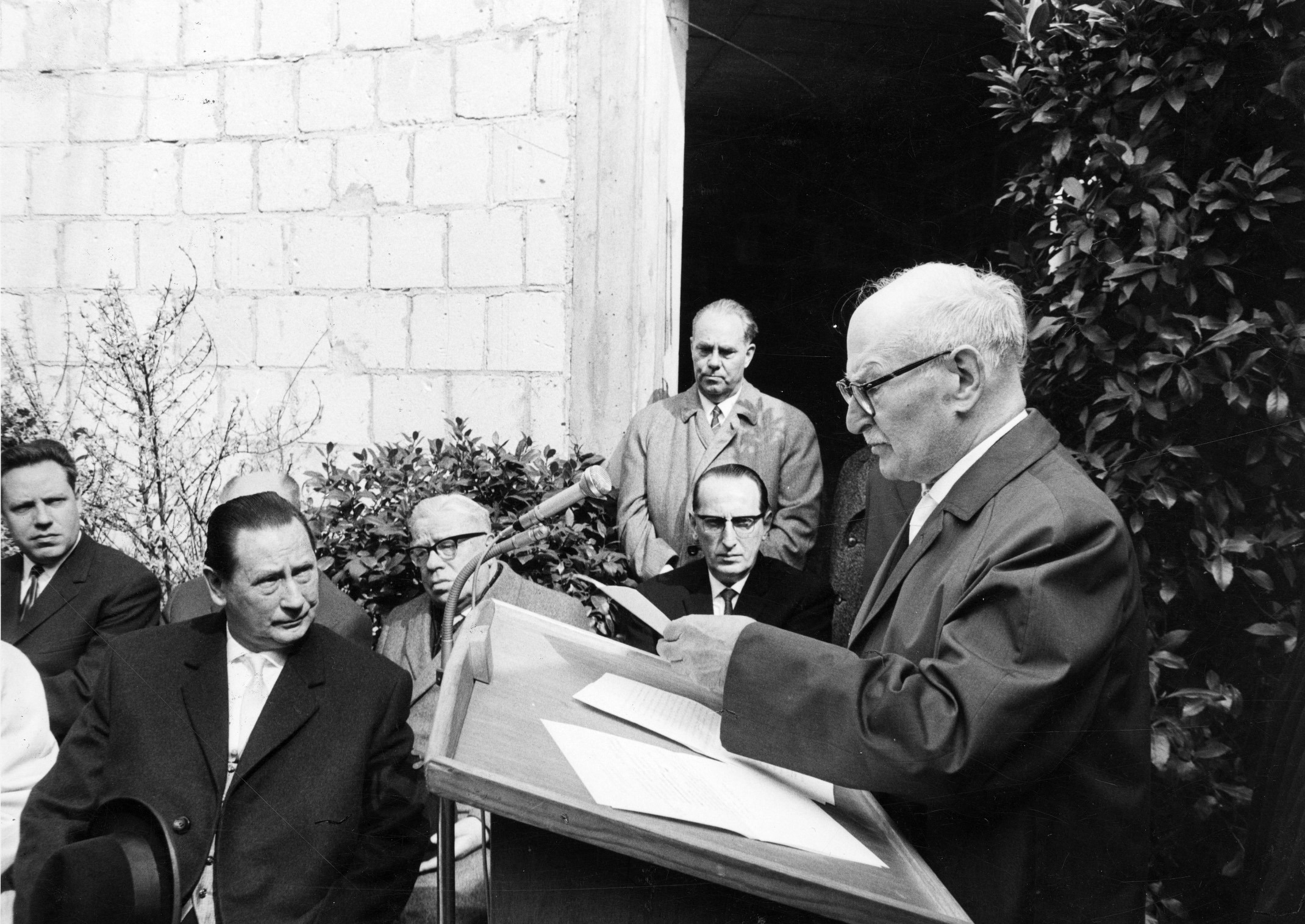 Д-р Фридрих Райхман, председатель еврейской общины Висбадена, открывает торжественную церемонию закладки первого камня в основание нового здания синагоги. Сидит слева: Вильгельм Фройнд. ШтадтА WI, F000-259